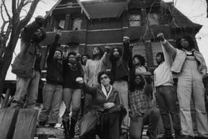 Move members in front of their house in the Powelton Village section of Philadelphia, Pennsylvania.